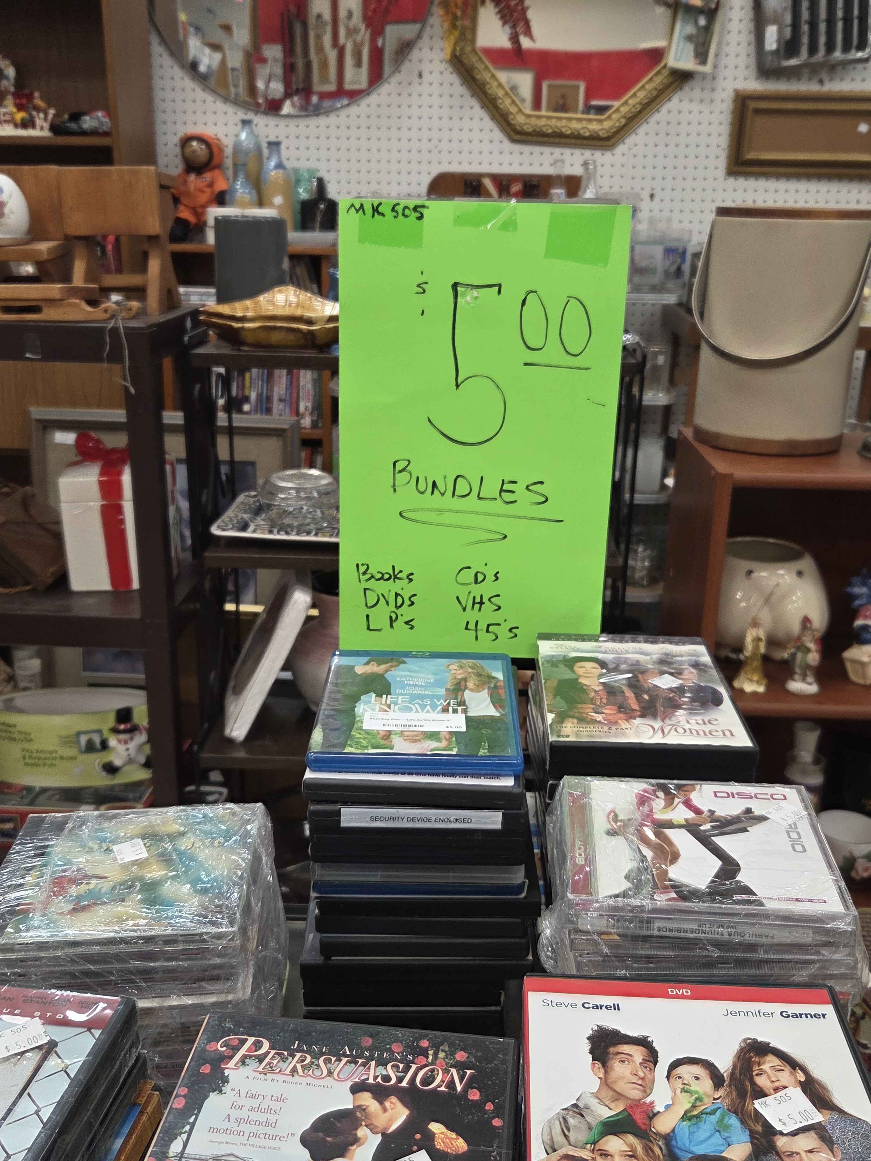 Bundles of random movies and cds being sold for $5